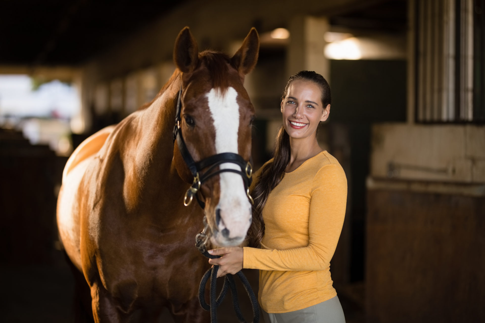 Photograph of a lady posing with a horse